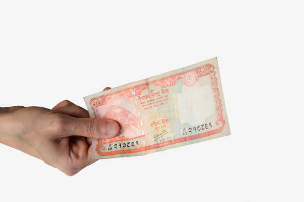 istock Woman holding a twenty Nepal Rupees note in her hand 832105316