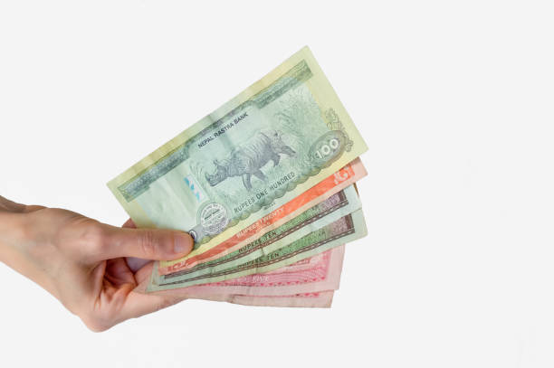 istock Woman holding Nepal Rupees notes in her hand 832105332