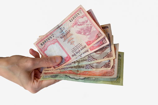 Woman holding Nepal Rupees banknotes in her hand