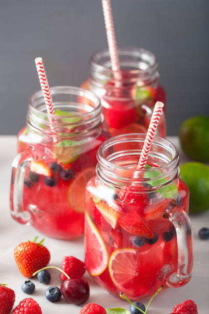 istock summer berry lemonade with lime and mint in mason jar 832105500