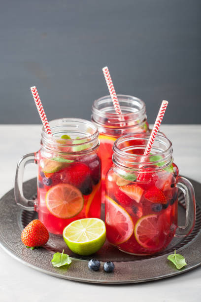 istock summer berry lemonade with lime and mint in mason jar 832105858