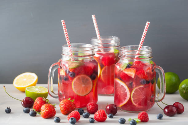 istock summer berry lemonade with lime and mint in mason jar 832107982