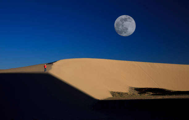 istock beautiful moon rises from the desert 832108062