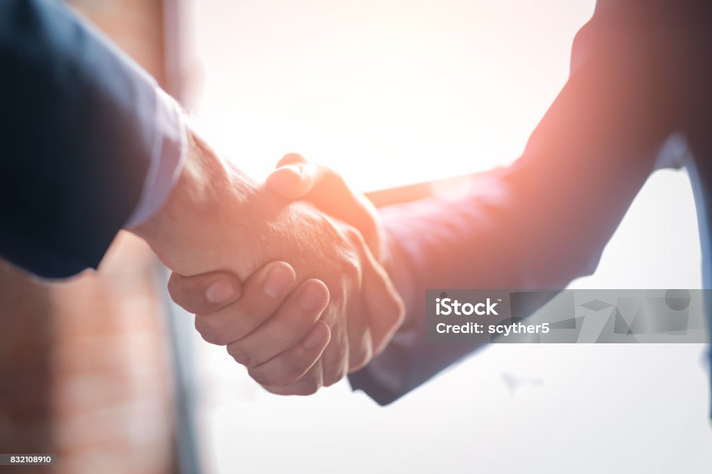 Business people shaking hands. Finishing up meeting. Business people shaking hands, finishing up meeting. Successful businessmen handshaking after good deal. Handshake Stock Photo