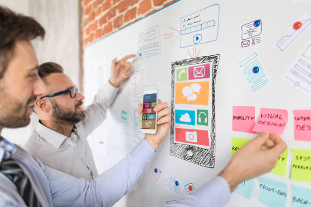 Designers drawing website ux app development. Designers man drawing website ux app development. User experience concept. application modernization stock pictures, royalty-free photos & images