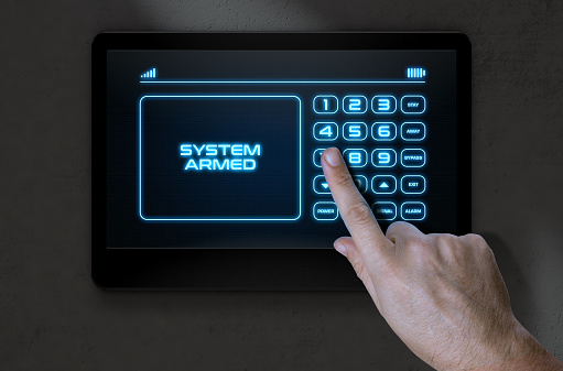 A male hand pressing the screen of a home security control panel with words that read system armed - 3D render