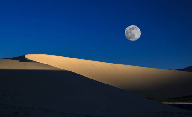 istock beautiful moon rises from the desert 832111830