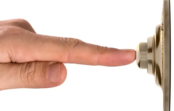 Photo of Finger Pressing Doorbell