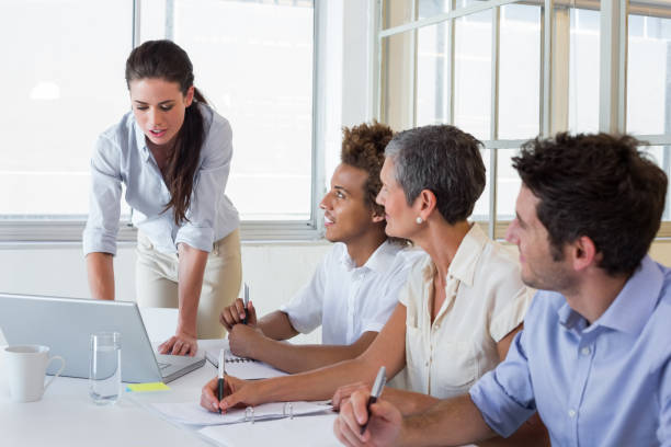 istock Business people using laptops and notebooks in meeting 832112738