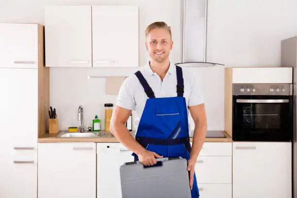 Portrait Of Happy Male Worker With Toolkit