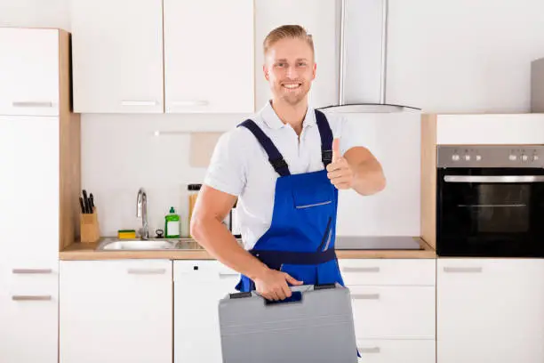Portrait Of Happy Male Worker With Toolkit