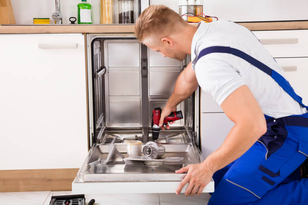 istock Repairman Fixing Dishwasher In Kitchen 832115400