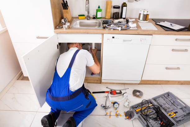 istock Plumber In Overall Repairing Sink Pipe 832115596
