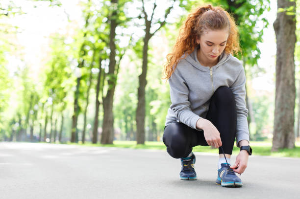 istock Woman tying shoes laces before running 832119890