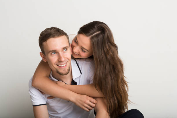 istock Happy man carrying his girlfriend on back 832120634