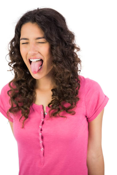 istock Long haired brunette sticking her tongue out 832120788