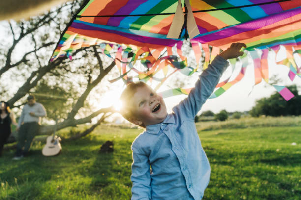 istock Child playing with kite in the meadow 832123034
