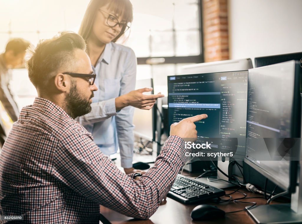 Website design. Developing programming and coding technologies. Developing programming and coding technologies. Website design. Programmer working in a software develop company office. Network Security Stock Photo