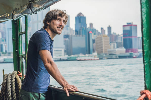 istock A young man on a ferry in Hong Kong 832129076