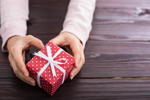 istock Christmas presents gift holding. 832129426