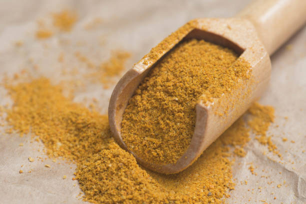 istock dried curry powder in measuring spoon 832130138