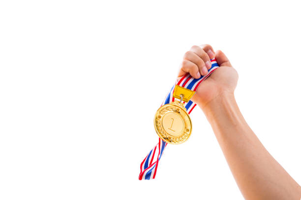 istock Number 1 winner holding medal gold award 832133682