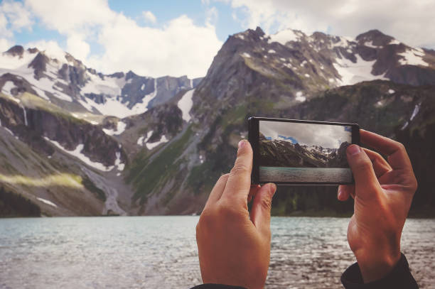 istock man hands holding mobile phone at Sea and mountains 832137138
