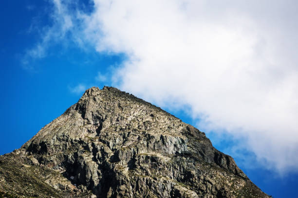 view of the summit on a blue sky background with white clouds in summer