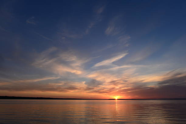 istock Sunset in the clear blue summer sky above the lake 832141542