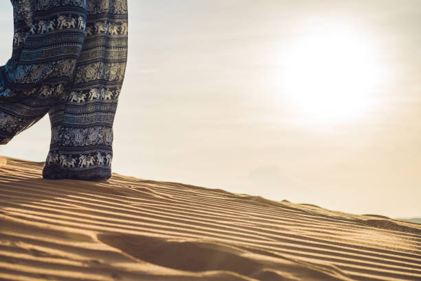 istock young woman in rad sandy desert at sunset 832142240