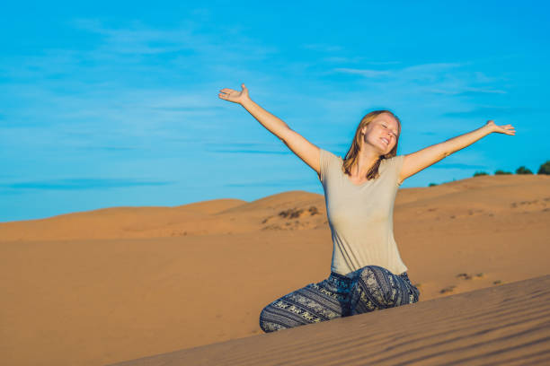 istock young woman in rad sandy desert at sunset 832143776