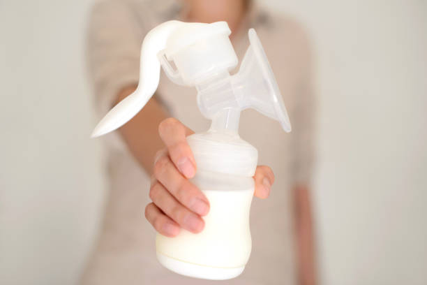 istock Mother holds breast pump in her hand 832147170
