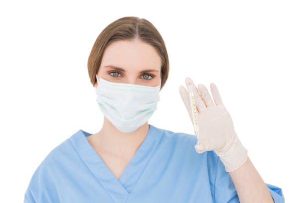 istock Pretty brunette female doctor holding a thermometer 832147984