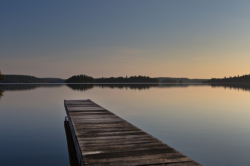 The sunrise over Burntside Lake, Ely Minnesota. Located in the Superior National Forest. Burntside Lake a popular tourist destination in the summer in Minnesota. Beautiful scenic area adjacent to the Boundary Water Canoe Area.