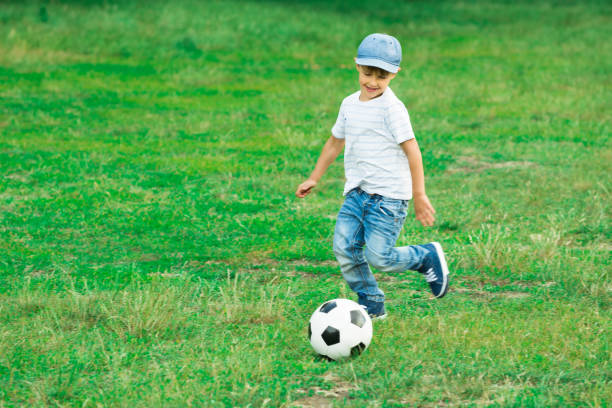 istock Boy Playing With Soccer Ball 832153770