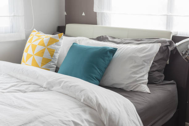 istock colorful pillows on white bed in modern bedroom 832153970