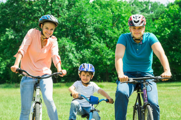 istock Happy Family Cycling In Park 832154026