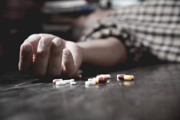 Close up of overdose pills and addict. stock photo