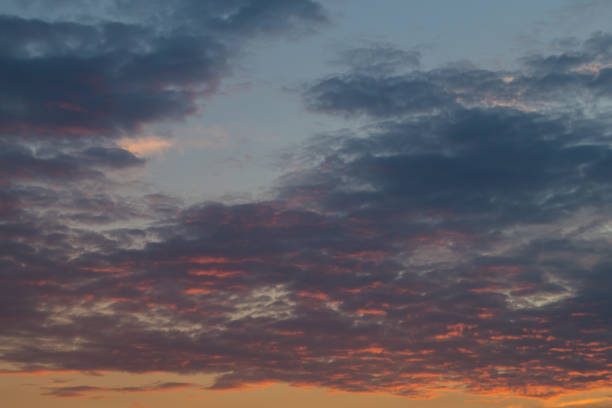 istock Dark bright blue and orange clouds on sunset or sunrise 832159520