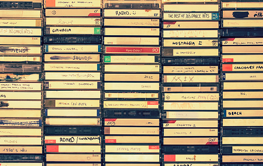 A background pattern made of vintage audio cassettes boxes