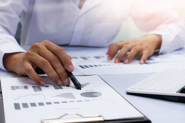 istock businessman working with business documents on office table with digital tablet computer and graph finance diagram in the background 832167322