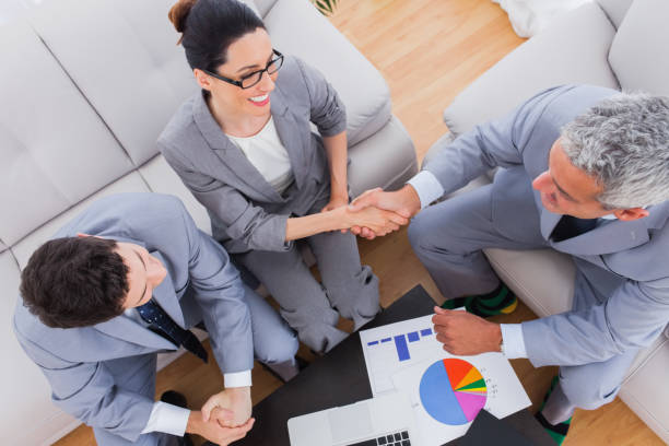 istock Smiling business shaking hands during meeting 832169916