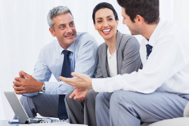 istock Happy business people working with their laptop on sofa 832171066