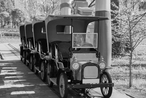 Old retro car carousel in the park. Sunny spring day. Black and White
