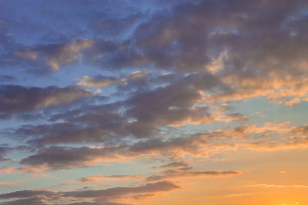 istock Beautiful clouds on the blue sky in the rays of the setting sun 832174928