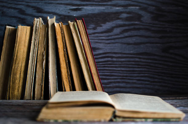 istock A stack of old books on a wooden table 832177752