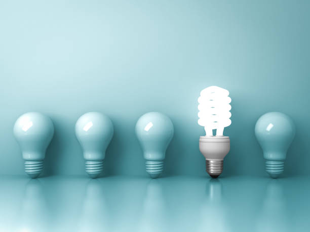 istock Eco energy saving light bulb , one glowing fluorescent lightbulb standing out from unlit incandescent bulbs reflection on green background , individuality and different ideas concepts . 3D rendering 832186956