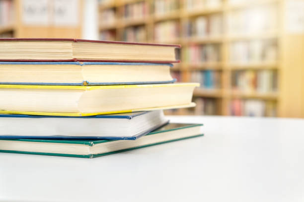 istock Stack and pile of books on table in public or school library. Education, studying and literature service concept with negative copy space. 832186982