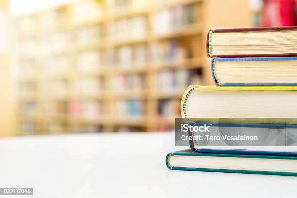 Stack And Pile Of Books On Table In Public Or School Library Education Studying And Literature Service Concept With Negative Copy Space Stock Photo - Download Image Now