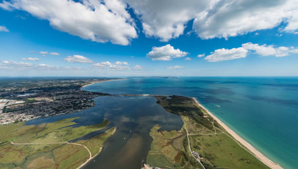 Aerial view over Christchurch Harbour and Hengistbury Head Aerial view over Christchurch Harbour and Hengistbury Head coastline on a sunny day. christchurch england photos stock pictures, royalty-free photos & images